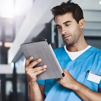 A doctor figure with an ipad in his hand.