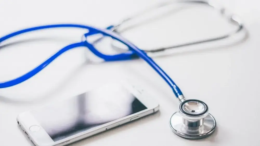 mHealth concept; stethoscope and mobile phone on a white background