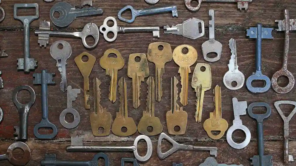 API security concept; keys of varying shapes and sizes on a wooden board