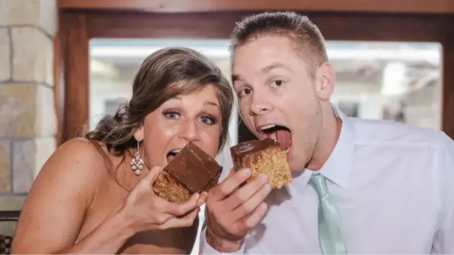Bride and Groom about to bite into chocolate cake