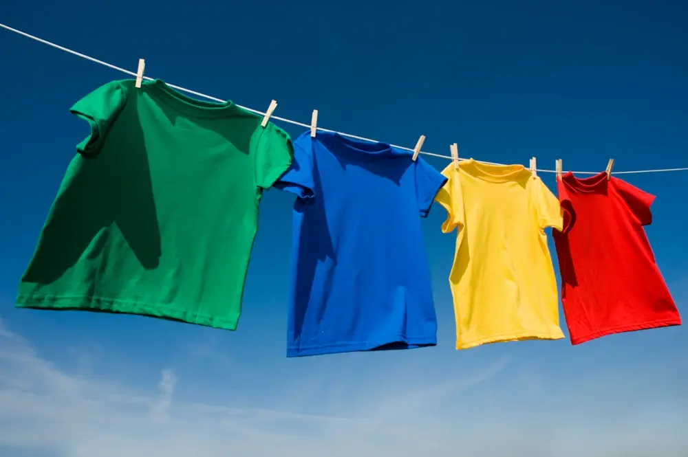 Colourful t-shirts pegged on a washing line