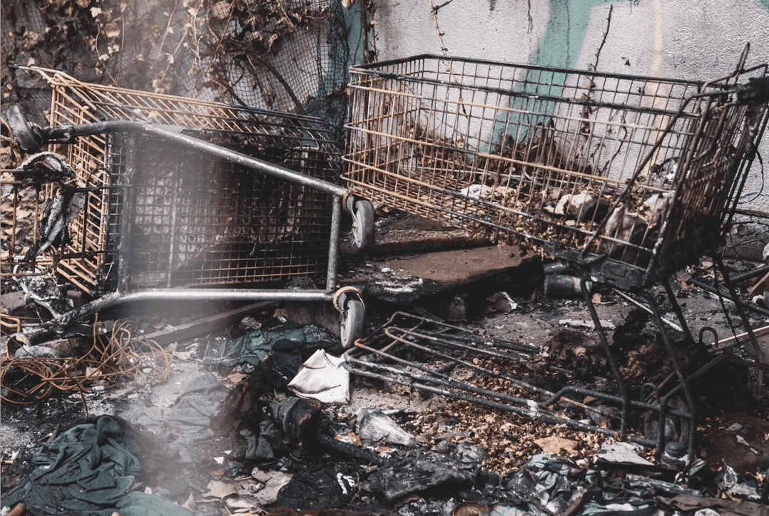abandoned shopping carts and clothing set on fire